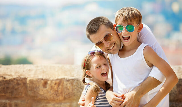 Father and children posing happily during their adventure in Athens for families.